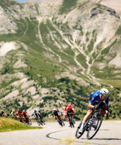 tour de france 2025 magazine cyclist with down hill mountain view